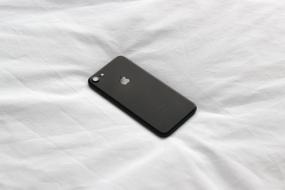 black iphone on white cloth
