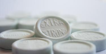Lozenges White Mint close-up in blurred background