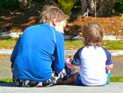 brother and sister talking on the street