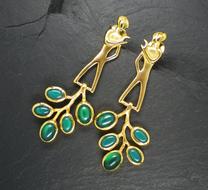 gold jewelry with green gemstones