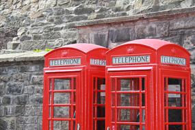 red telephone booths near the building