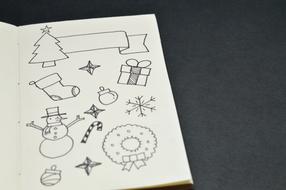 drawings on a white sheet in a notebook