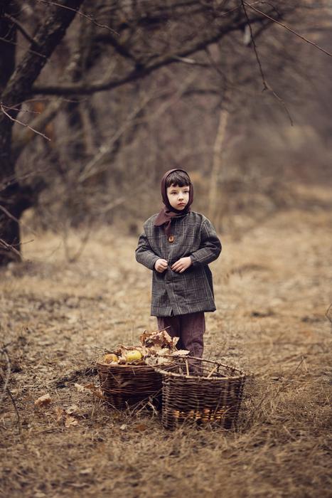 boy with baskets full of apples