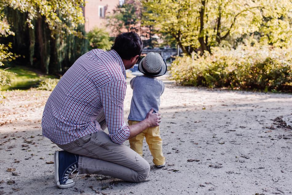 Father with the son, on the road among the beautiful and colorful plants