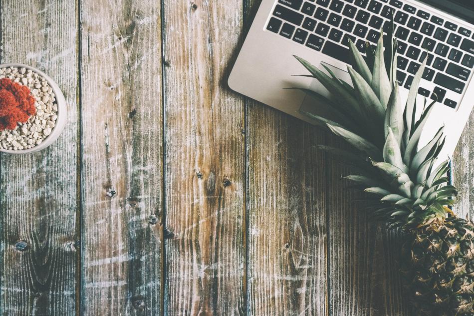 Light on the pineapple near the laptop on the table