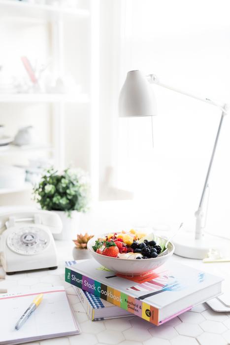 Fruits in bowl on stack of books