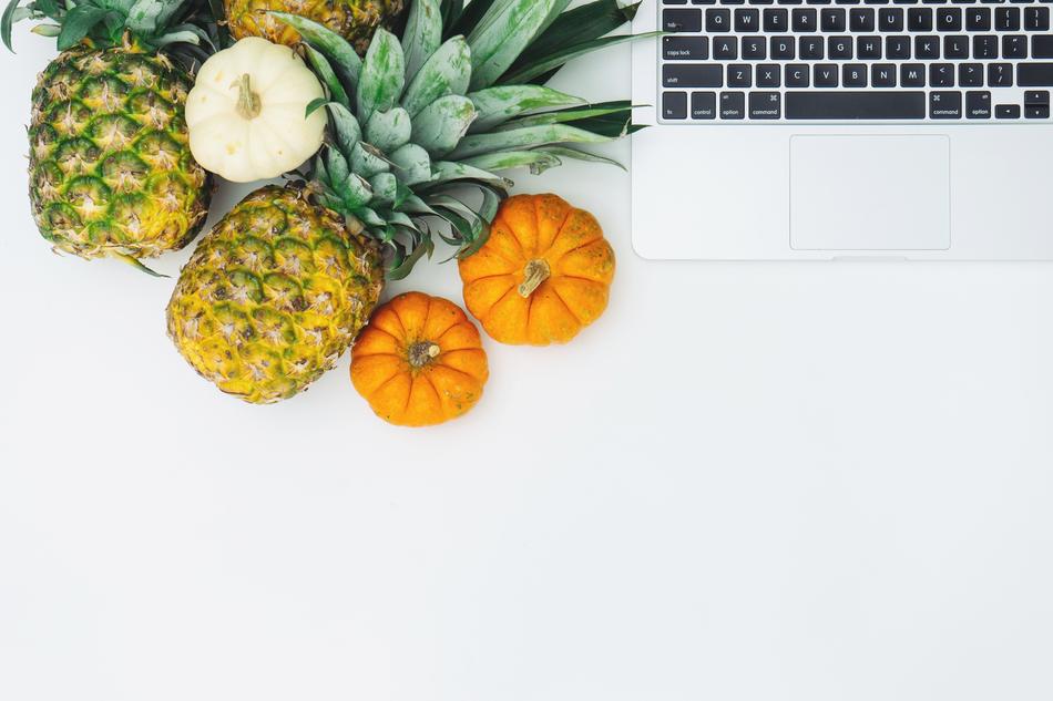 pineapples, pumpkins and laptop on the table