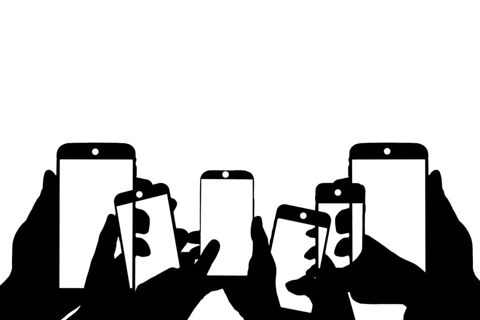 silhouette of smartphones in the hands of people