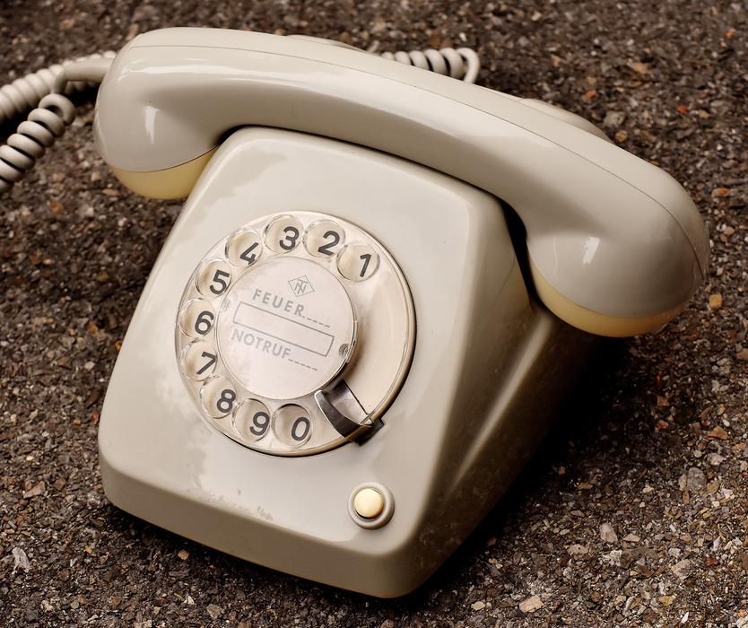 Close-up of the shiny, grey and yellow phone of the 60s