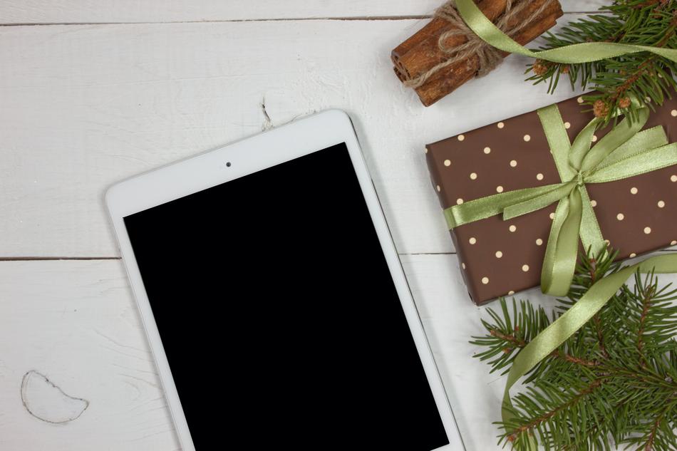 tablet and christmas gifts on the table
