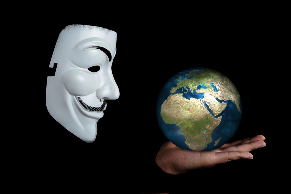man in white mask holding globe