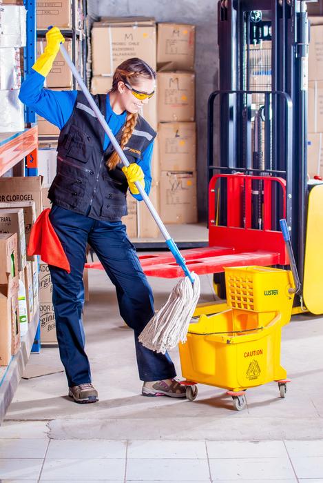 cleaner in work clothes at an industrial plant
