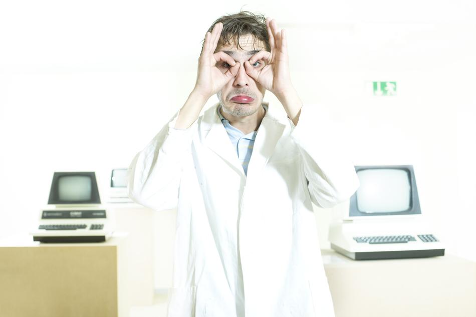 man in white coat near computers