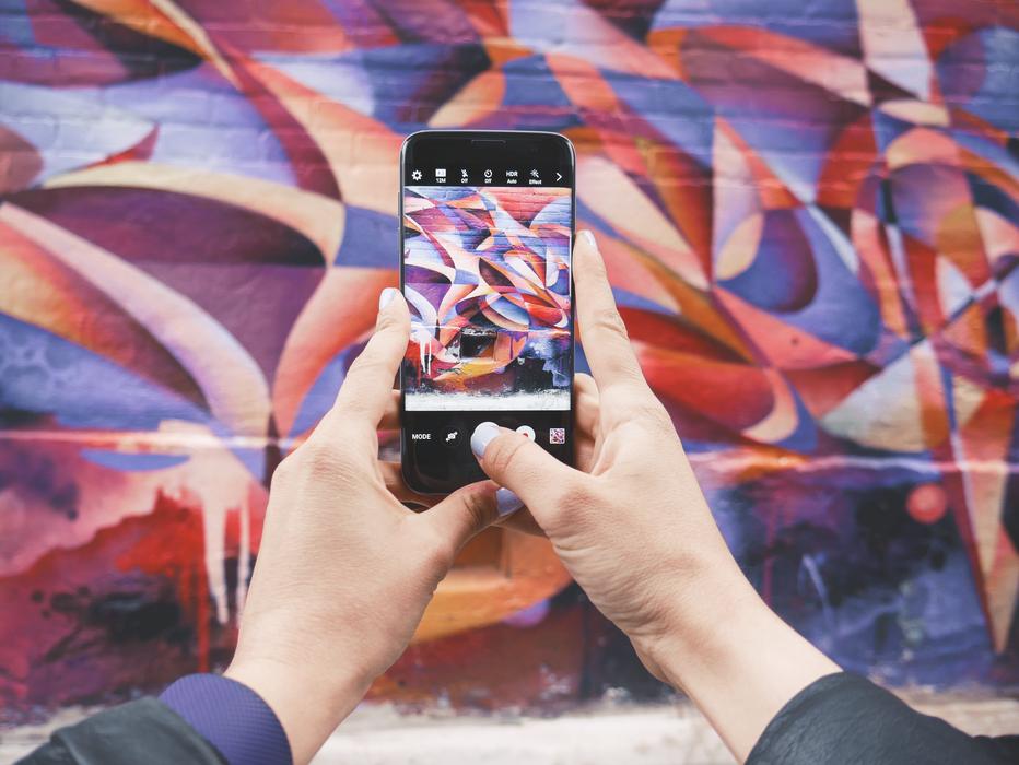 take pictures of colorful graffiti on the wall