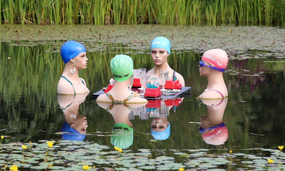 funny figures of swimmers on the water