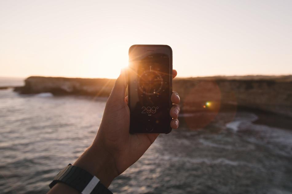compass on smartphone screen on the background of the coast