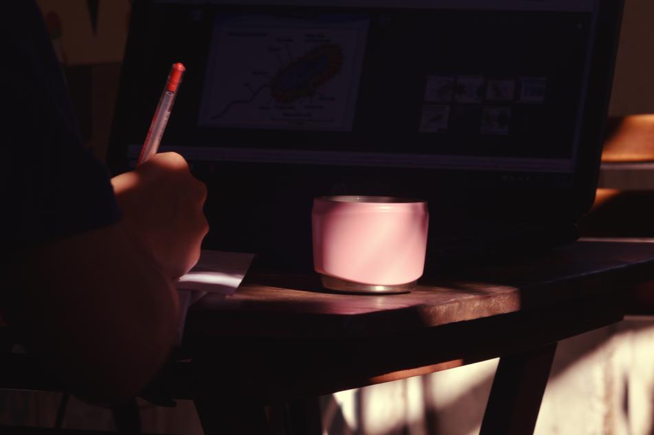laptop, cup of tea, writing on the desk