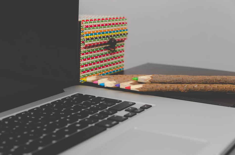 Beautiful and colorful, wooden pencils and box, near the laptop