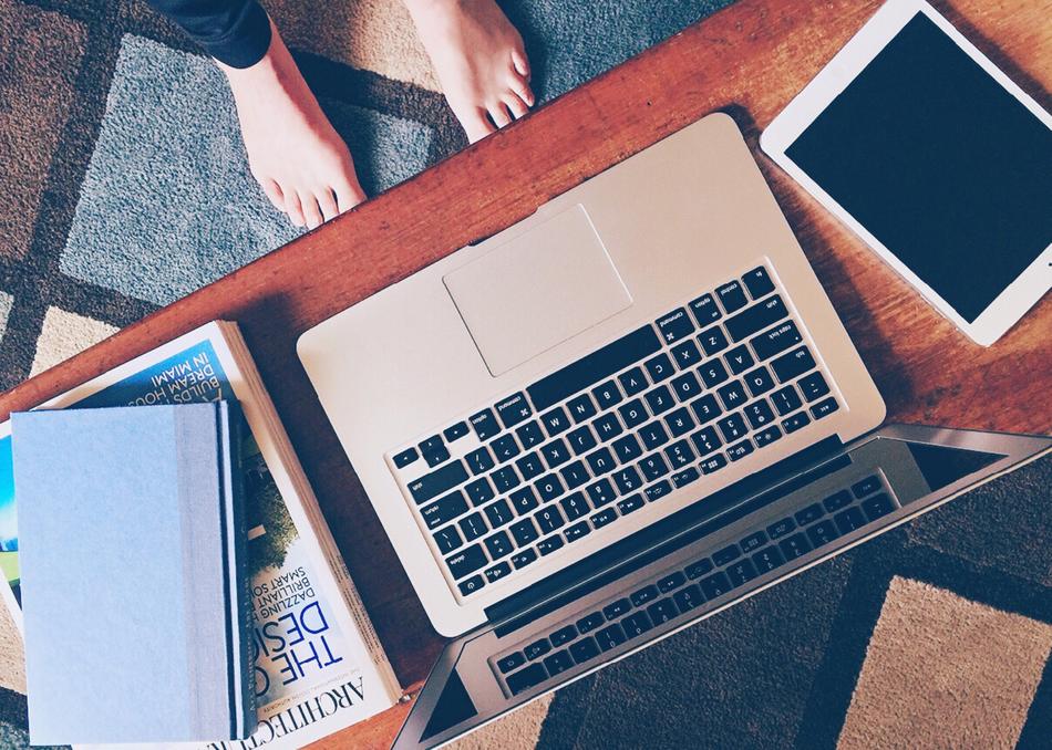 work at Home, bare feet on floor and Laptop on desk, top view
