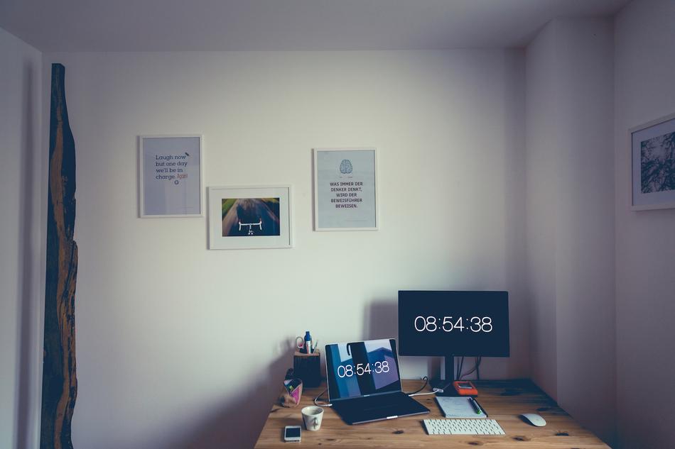 two computers on Desk in room