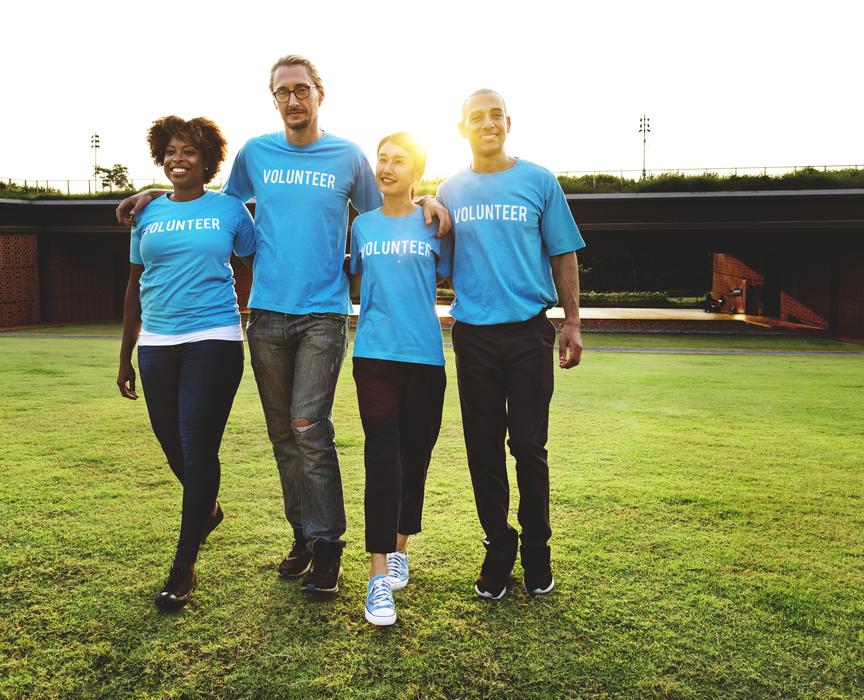volunteers from different countries stand on the lawn