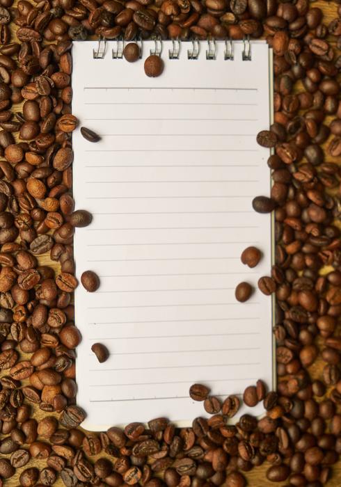 notepad and roasted coffee beans
