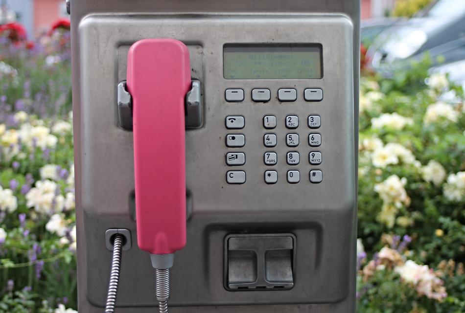 payphone with pink tube close up