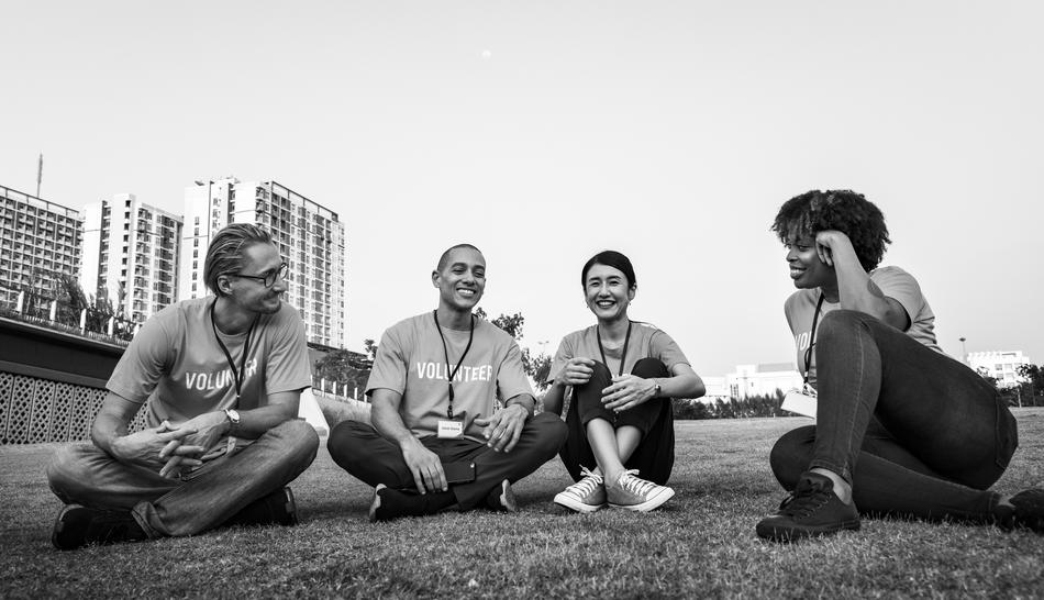 black and white photo of volunteers from different countries on the lawn