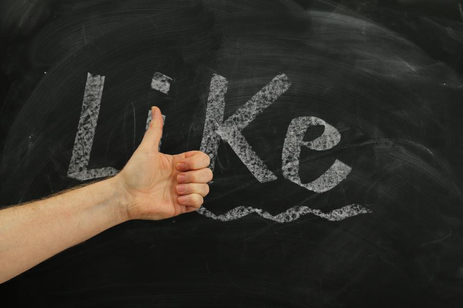 like, Thumb up gesture at lettering on blackboard