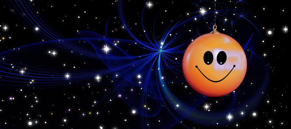 Orange and black Smilie decorations, at background with beautiful, black space with stars and blue light