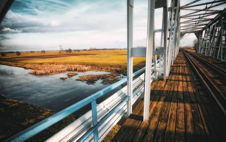railway bridge in countryside at fall