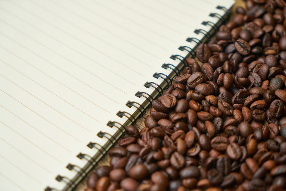coffee beans next to the notebook