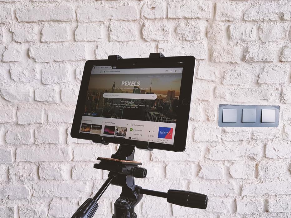 Tablet, on the tripod, near the white wall, with the light switches
