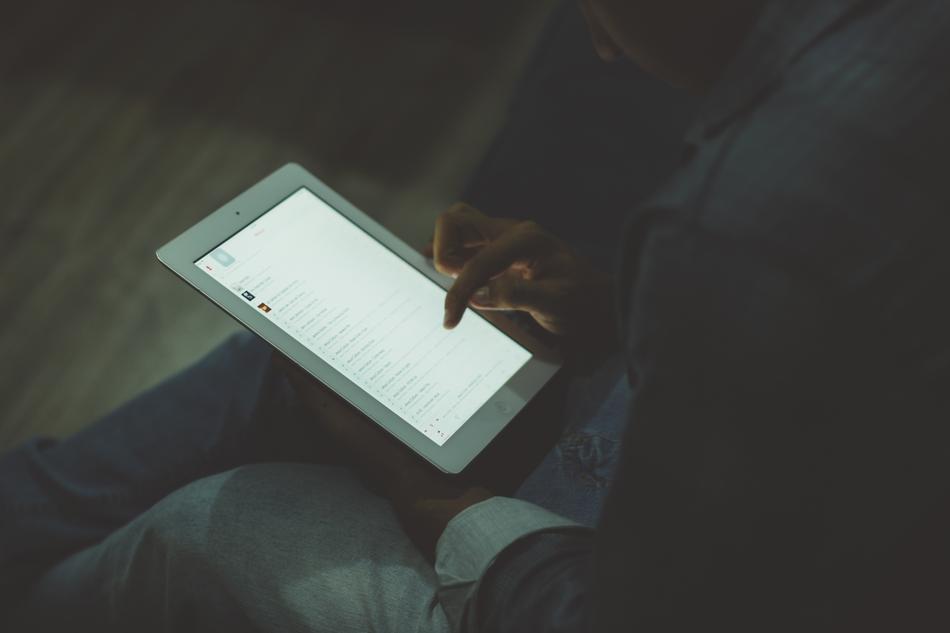 tablet in hands in the dark