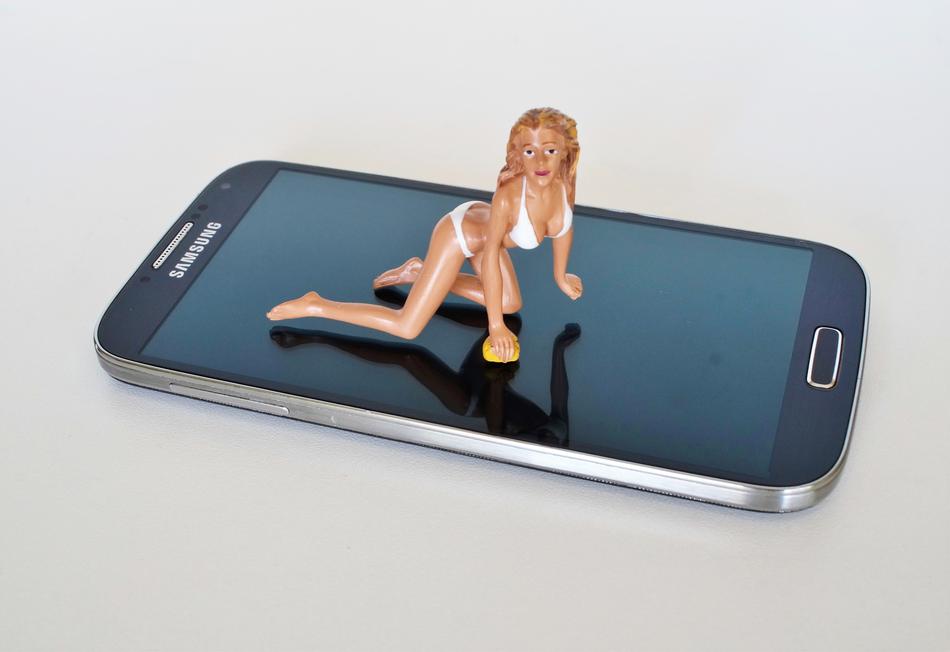 figurine of a girl in a bikini on a smartphone screen