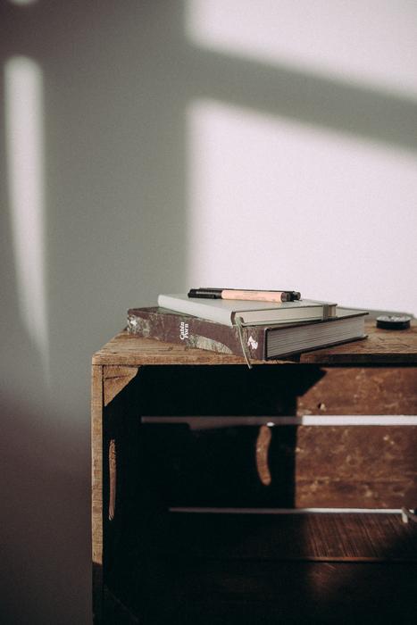 table with books near the wall