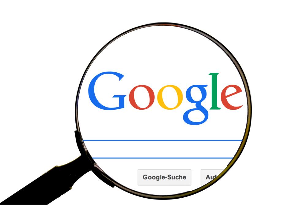 magnifying glass over google