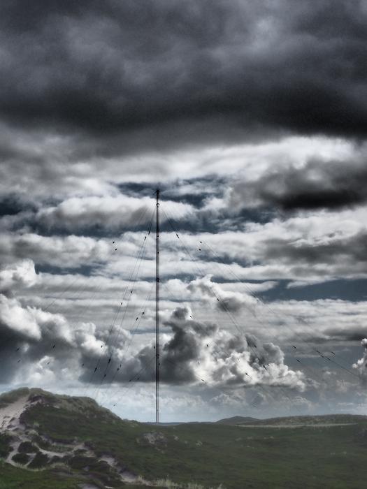 radio tower against the background of clouds and stormy sky