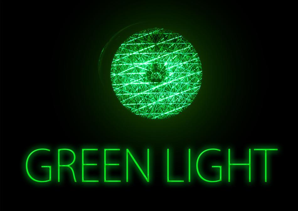 Green, neon 'GREEN LIGHT' sign and globe, at black background, on clipart