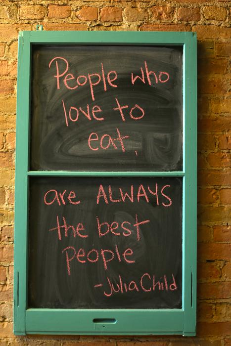 Red writing of Julia Child, on the chalkboard in green frame
