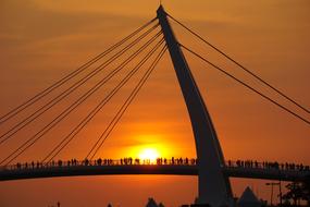 suspension bridge at orange dusk