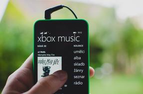 smartphone with included music in the river on a blurred background