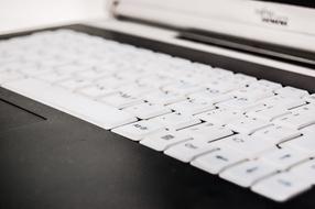 white keyboard, black laptop