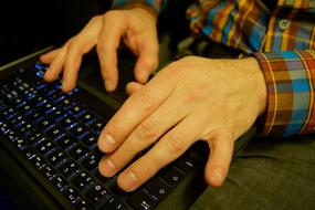 Hands typing on Laptop Pc keyboard