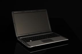 black laptop on black surface