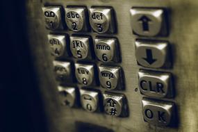 Close-up of the shiny, grey and black phone numbers, among the shadows