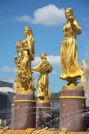 golden statues at the fountain in moscow