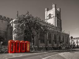 red telephone booths in the historic architecture of Cambridge