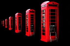 red telephone booths in black background