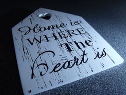 Beautiful house tablet with black sign and heart shape, in light